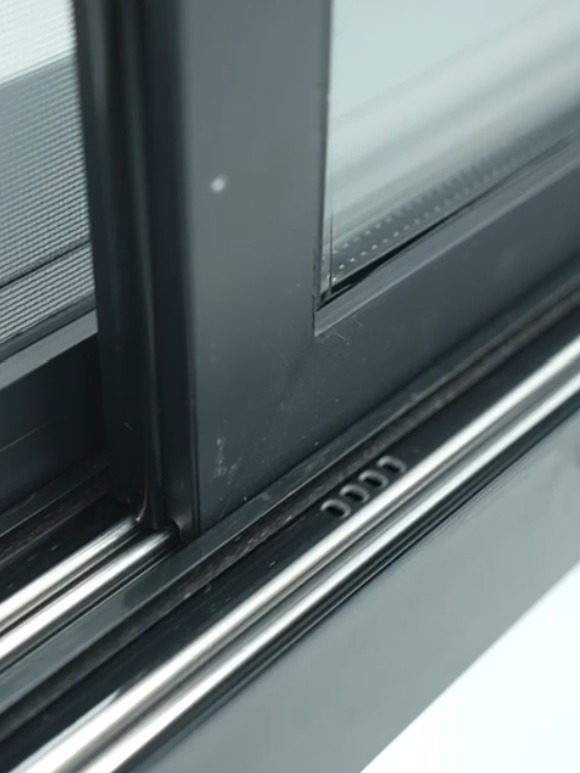Stainless rails and weep holes in the bottom track